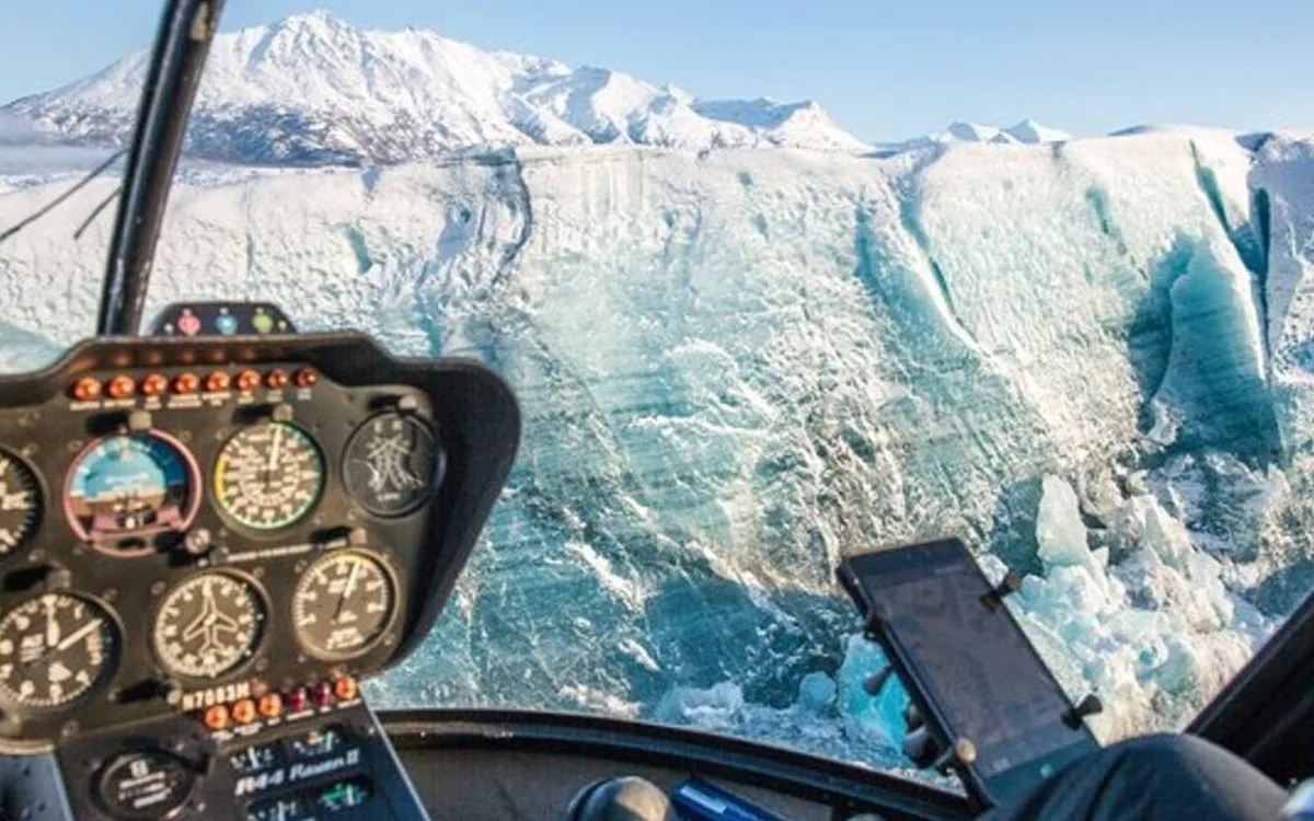 The view from a helicopter cockpit over a glacier in Alaska