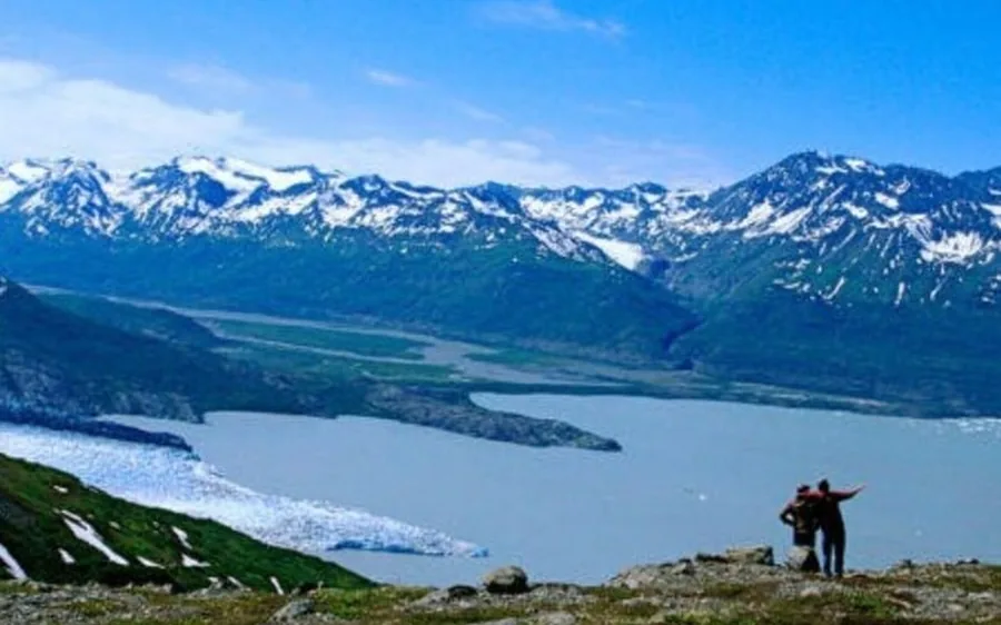 Walkers on the surface of Knik Glacier beside a helicopter, Alaska