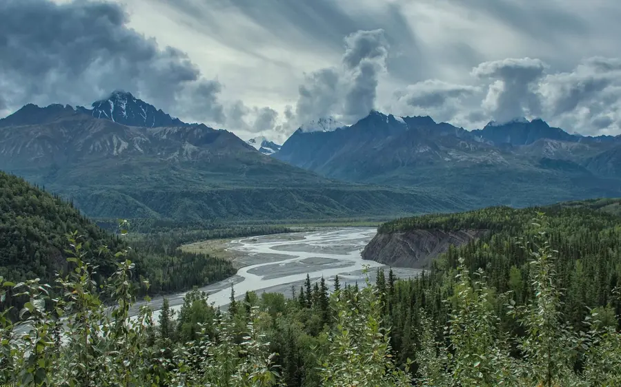 A tour van parked beside Matanuska Glacier in Alaska