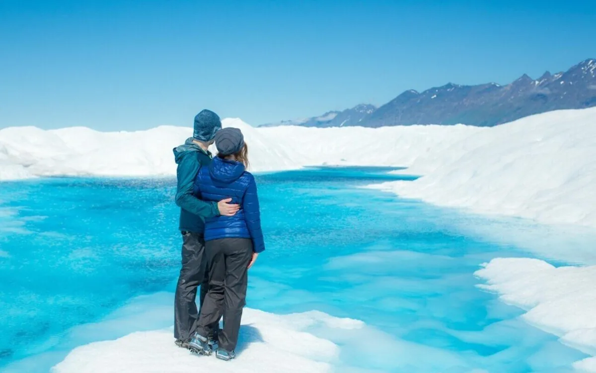 A turquoise meltwater lake on the surface of a glacier in Alaska
